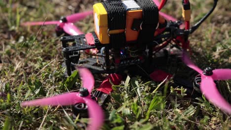 Closeup-Of-DIY-Quadcopter-FPV-Drone-Camera-Starting-To-Launch-From-The-Ground