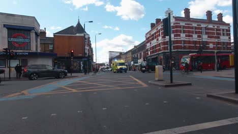 An-UK-ambulance-speeds-through-a-busy-London-intersection-with-the-lights-and-siren-on