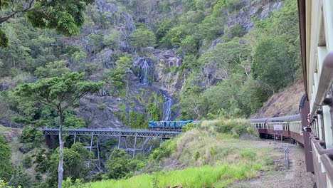 Kuranda-Scenic-Railway-With-View-Of-Stony-Creek-Falls-Follow-Shot,-Slow-Motion