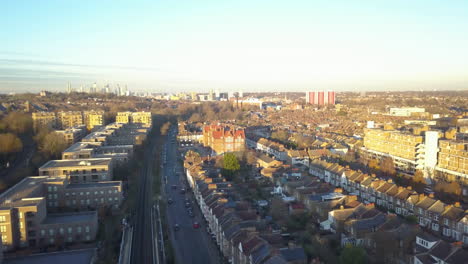 Aerial-bird's-eye-view-of-suburb-of-London-with-railway-and-train,-UK