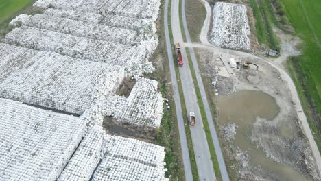 drone-approaching-landfill-dump-junkyard-with-cube-of-plastic-inorganic-pollution-toxic-waste-garbage