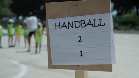Slow-establishing-shot-of-children-getting-ready-to-play-a-handball-game