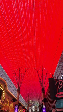 Vertical-Video,-Fremont-Street-Experience-in-Downtown-Las-Vegas-Nevada-USA,-People,-LED-Screens-on-Ceiling-and-Buildings
