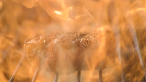 Sizzling-steak-close-up-on-a-grill,-capturing-the-juice-and-flames-in-super-slow-motion