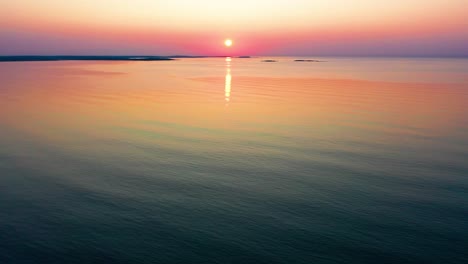 Colorful-Ocean-Sunrise-in-Saco,-Maine-with-Bright-Colors-Reflecting-off-Calm-Rippling-Sea-Waves-Along-the-New-England-Atlantic-Coastline