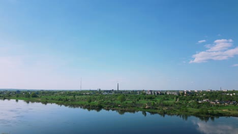 Fixed-aerial-of-Daugavpils-skyline-next-to-Daugava-river-during-spring