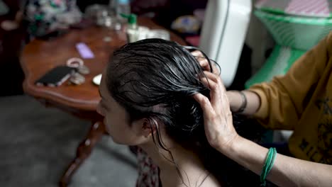 Woman-Massaging-Hair-And-Scalp-With-Oil-Of-A-Young-Woman