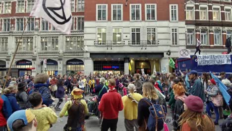 Extinction-Rebellion-Protesters-dance-to-raise-awareness-in-front-of-Tesco-Metro-in-Liverpool-street-station