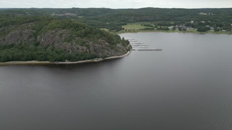 Aerial-flight-to-small-marina-on-Nordic-lake-in-Swedish-countryside