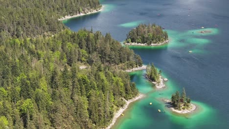 Aerial-view-of-Eibsee-in-Grainau,-Germany,-highlighting-turquoise-waters,-lush-forest,-and-small-islands