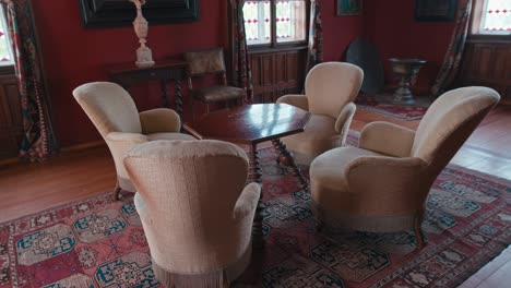 Julijana-Room-in-Trakošćan-Castle-,-Croatia,-featuring-vintage-armchairs-around-a-wooden-table
