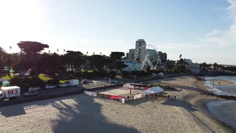Aerial---Beach-volleyball-court-in-beautiful-setting-with-ferris-wheel-in-the-background