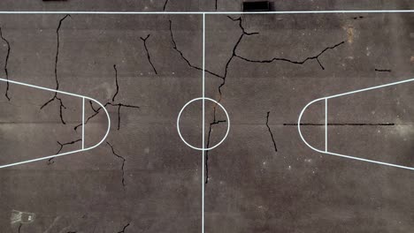 Old-Basketball-Court-With-Cracks-On-Ground-In-Rauna,-Latvia
