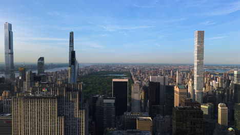 Drone-shot-flying-in-front-of-midtown-highrise-and-the-Central-Park,-sunset-in-NY