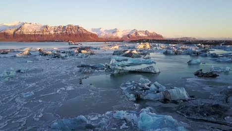 Scenic-Views-Across-a-Lake-of-Icebergs-During-Morning-Sunrise-in-Iceland