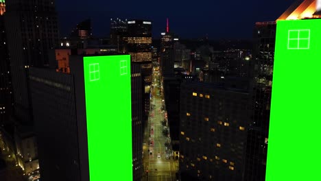 Green-screens-on-skyscrapers-in-dark-American-city