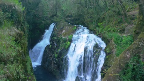 Fly-Away-At-Santa-Leocadia-Waterfall-In-Tropical-Forest-Near-Mazaricos-In-Galicia-Spain