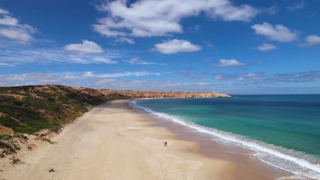 A-couple-walking-along-a-beautiful-beach-in-South-Australia