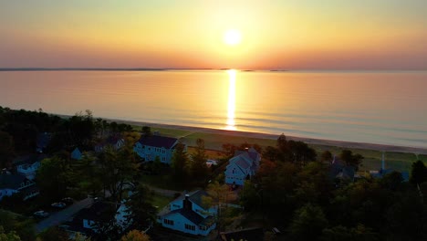 Luftaufnahme-Eines-Wunderschönen-Sonnenuntergangs-Am-Strand-In-Saco,-Maine,-Mit-Ferienhäusern-Und-Farben,-Die-Sich-In-Den-Meereswellen-Entlang-Der-Atlantikküste-Von-Neuengland-Spiegeln
