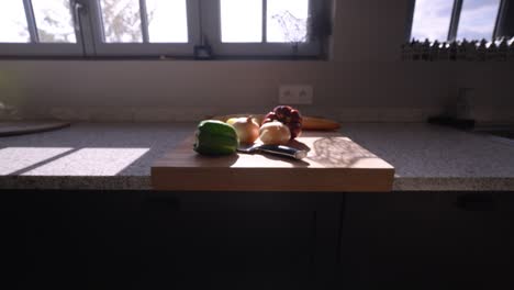 Slow-establishing-shot-of-a-selection-of-vegetables-sitting-on-a-chopping-board