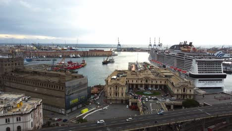 Genoa's-busy-port-with-cruise-ships-and-historic-buildings,-cloudy-day,-aerial-view