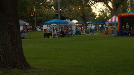 A-wide-shot-of-a-local-business-fair-and-farmers-market-in-the-small-city-park-in-the-evenings