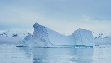 Large-Antarctica-Iceberg-Seascape-Sunset,-Big-Massive-Blue-Icebergs-with-Amazing-Shapes-and-Dramatic-Couds-and-Sky-in-Sunrise-Winter-Landscape-Scenery-on-Antarctic-Peninsula-in-Icy-Scene