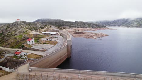 Drone-Shot-Of-a-Dam-in-a-Mountain-Lake