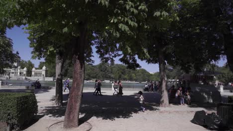 Little-girl-walking-in-Retiro-park-in-Madrid-in-front-of-lake