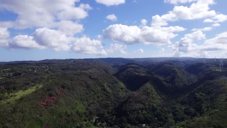 aerial-footage-on-the-North-Shore-of-Oahu-Hawaii-rotating-to-show-the-mountainous-rainforest-region-turning-to-show-the-view-of-the-Pacific-ocean-on-a-sunny-day