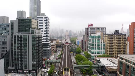 Explosión-Aérea-Tomada-Sobre-Las-Vías-Del-Metro-En-La-Ciudad-De-Nueva-York,-Revela-El-Puente-De-Queensboro-En-Queens