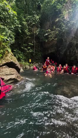 Rafting-participants-sliding-on-the-water-stream-one-by-one-at-natural-river-at-mountain