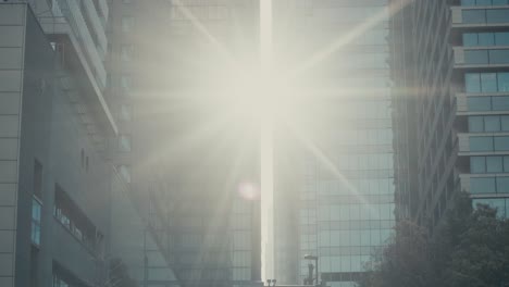Sun-Flares-Through-Modern-Skyscrapers-In-Tokyo-City,-Japan