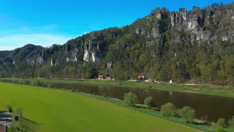 Elbe-river-at-Kurort-Rathen-village,-aerial-drone-shot,-Germany,-forward,-day