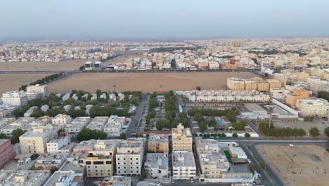 Aerial-tilting-shot-over-the-Saudi-Arabian-city-Jaddah-showcasing-large-fields-at-blue-the-hour