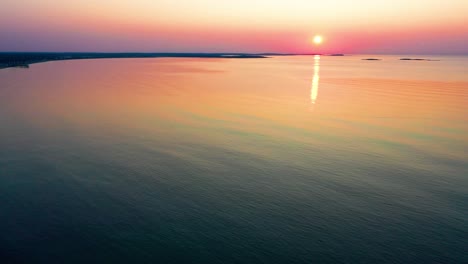 Colorful-Beach-Sunrise-in-Saco,-Maine-with-Bright-Colors-Reflecting-off-Calm-Rippling-Ocean-Waves-Along-the-New-England-Atlantic-Coastline