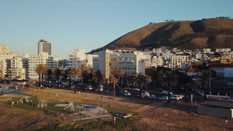 Drone-following-a-busy-street-near-the-skyline-of-Cape-Town-South-Africa