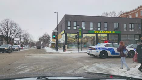 Police-Car-Driving-Fast-On-Snowy-Street,-Responding-To-Motor-Vehicle-Accident-In-Montreal,-Canada