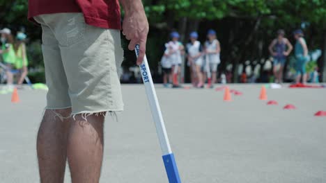 Slow-motion-shot-of-a-child-holding-a-hockey-stick-and-ball-waiting-to-play