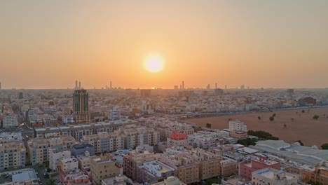 Scenic-aerial-shot-over-Saudi-Arabian-city-Jeddah-at-sunset-showing-a-busy-road-and-a-contoured-horizon-silhouette