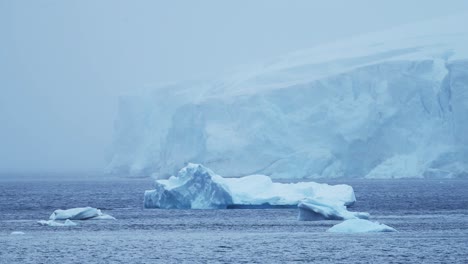 Antarctica-Winter-Glacier-Landscape-with-Icebergs-on-Coast-in-Cold-Blue-Antarctic-Peninsula-Scenery-with-Snowy-Snow,-Ice-and-Glacier-in-Dramatic-Beautiful-Coastal-Scene-with-Ocean-Sea-Water