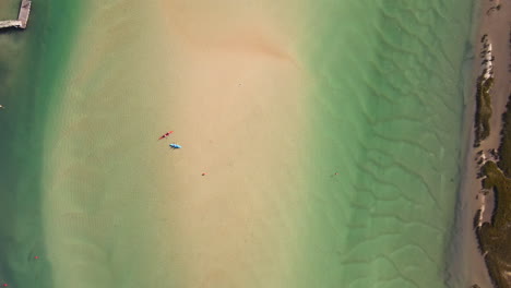 Kayaks-and-swimmers-in-clear-Goukou-estuary,-Still-Bay