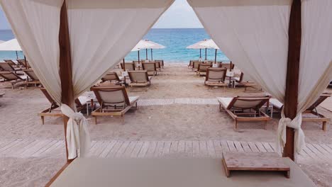 Kathisma-Beach,-Lefkada-Ionian-Island,-Greece---Fly-trough-Copla-Lefkada-Beach-Bar-with-Sun-Beds-and-Parasols