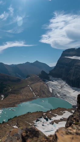 Vertical-4k-Timelapse,-Glacier-National-Park-Montana-USA,-Clouds-and-Sunny-Day-Above-Glacier,-Glacial-Lakes-and-Peaks