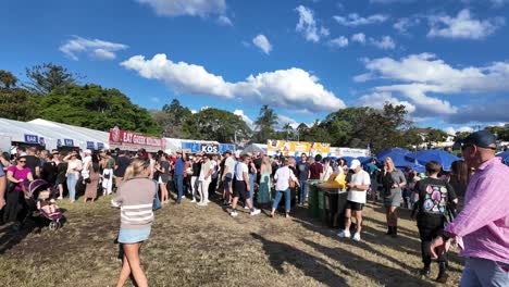 Large-crowd-attending-at-Paniyiri-Greek-Festival-in-Brisbane,-Australia-enjoying-some-greek-cuisine-and-atmosphere