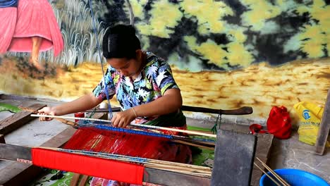 Local-residents-in-Lombok-while-knitting-fabrics-using-traditional-looms-in-Lombok---West-Nusa-Tenggara-Indonesia