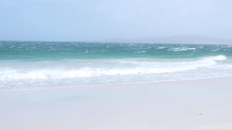 Scenic-view-of-wild-white-wash-waves-and-turquoise-water-ocean-rolling-into-sandy-beach-of-West-Beach-in-Berneray,-Outer-Hebrides-of-Western-Scotland-UK