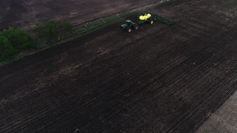 A-slow-right-to-left-orbit-of-a-John-Deere-tractor-seeding-a-field