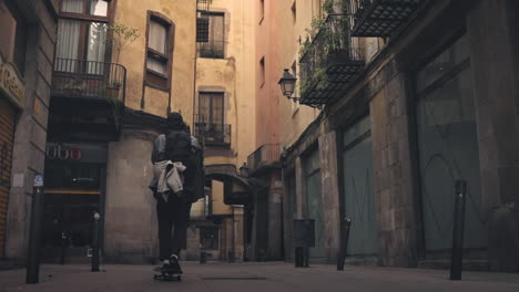 SKATEBOARDING---Skater-riding-down-an-alleyway-in-Barcelona,-Spain,-slow-motion