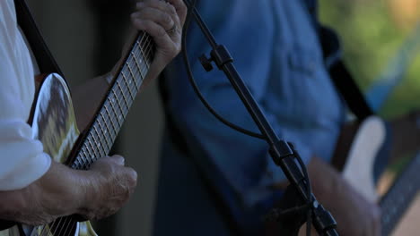 Country-musicians-play-guitar-at-concert,-close-up-shot